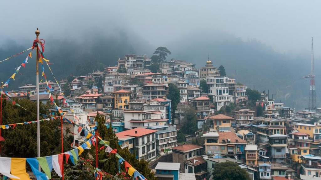 Majestic Northeast Retreat - Gangtok hillside with prayer flags and misty Himalayan peaks